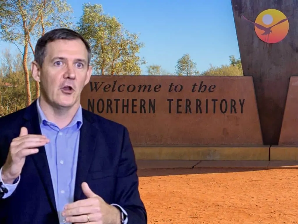 Gunner and border sign Michael Gunner with an image of the Northern Territory border