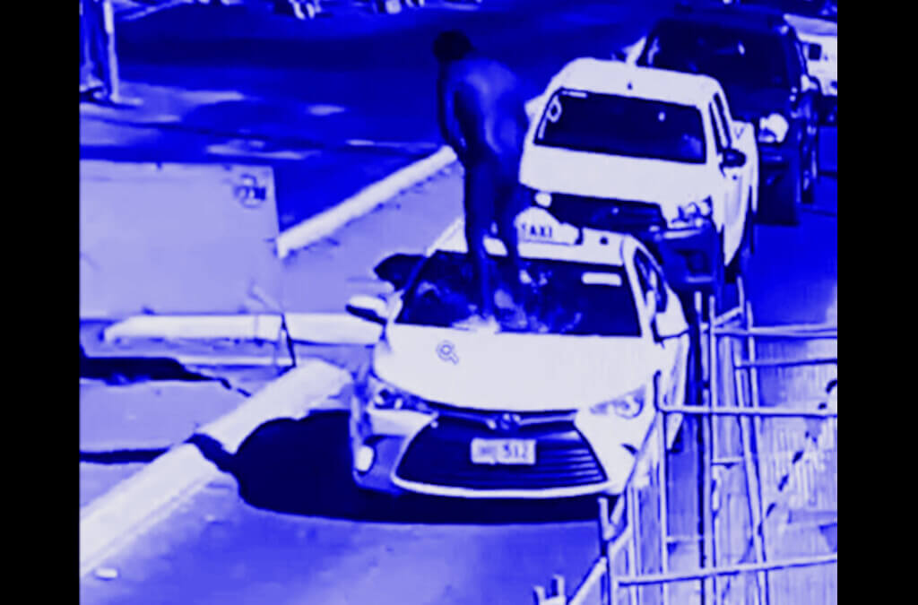 Videos: Naked man holding his penis climbs on taxi, smashes windscreen